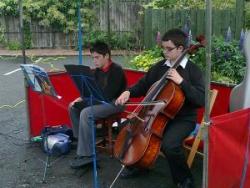 A young cellist entertains the crowd at the June Farmers' Market
